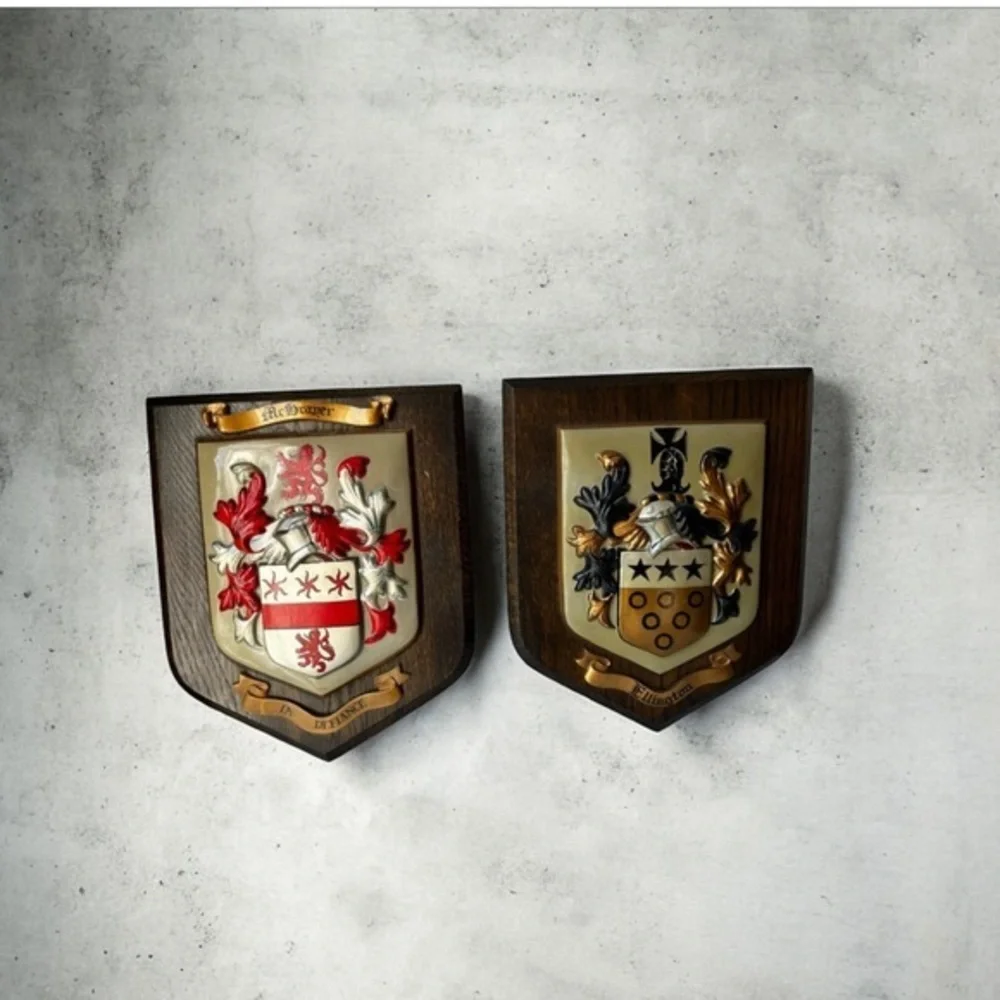 wooden plaques featuring family crests or coats of arms. McBrayer and Fllington.